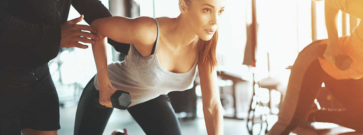 Personal Trainer Teaching Client Strength Training